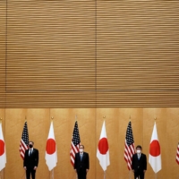 U.S. Secretary of State Antony Blinken and Defense Secretary Lloyd Austin meet with Prime Minister Yoshihide Suga, Foreign Minister Toshimitsu Motegi and Defense Minister Nobuo Kishi at the Prime Minister\'s Office in Tokyo on March 16. | POOL / VIA REUTERS