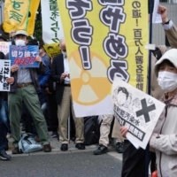 Demonstrators protest against the Japanese government\'s plan to release treated water from the stricken Fukushima nuclear plant into the ocean, in Tokyo on Tuesday.  |  AFP-JIJI