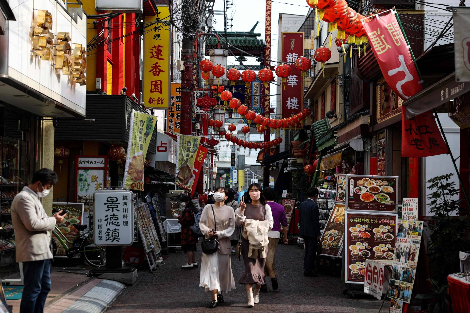 People walk through the Chinatown area in Yokohama on April 8. | AFP-JIJI
