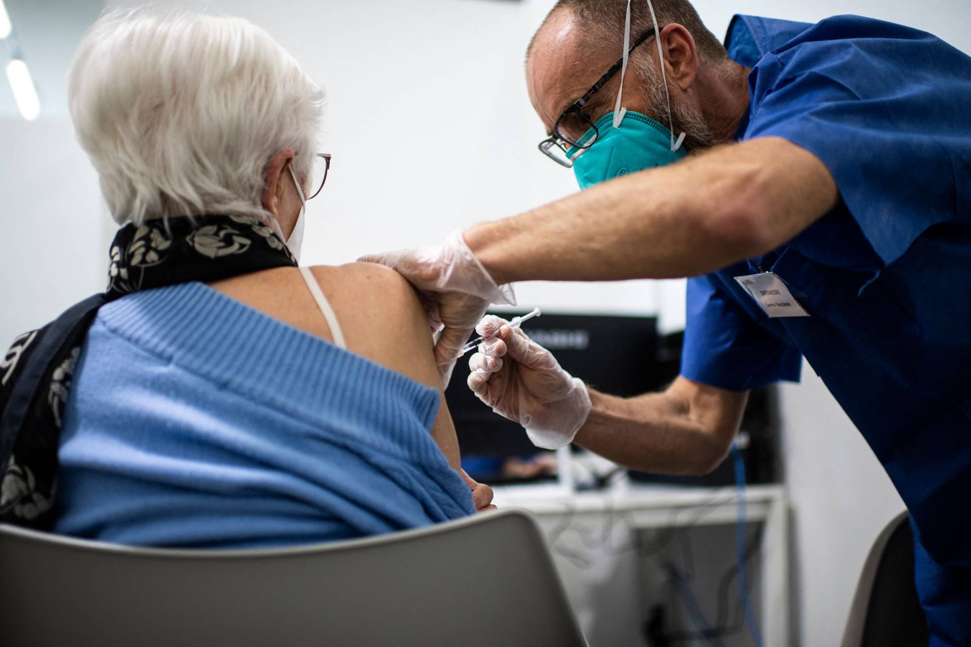 A medical worker administrates a dose of the Pfizer-BioNTech COVID-19 vaccine at a new vaccination hub in Lingotto Fiere Torino Pavilion in Turin, Italy, on April 14. | AFP-JIJI