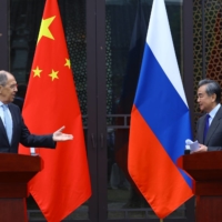 Russian Foreign Minister Sergey Lavrov and Chinese State Councilor Wang Yi attend a news conference following their meeting in Guilin, China, on March 23.  | RUSSIAN FOREIGN MINISTRY / VIA REUTERS 