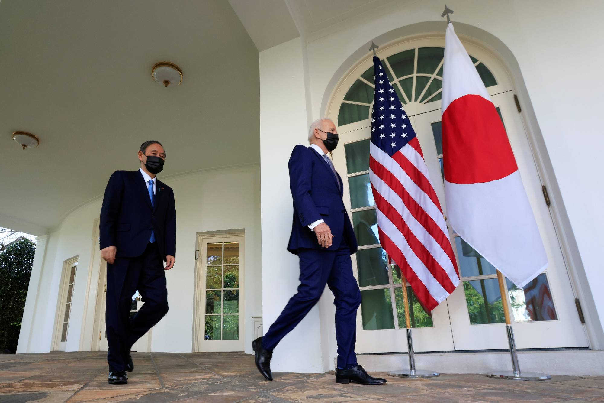U.S. President Joe Biden walks out of the Oval Office with Prime Minister Yoshihide Suga ahead of a news conference at the White House in Washington on Friday. | REUTERS