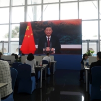 Chinese President Xi Jinping is displayed on a screen at a media center as he delivers a speech at the Boao Forum for Asia, in the town of Boao, in China\'s Hainan province, on Tuesday. | REUTERS 