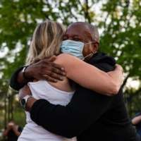 People embrace in Black Lives Matter Plaza in Washington on Tuesday after the verdict is announced in the trial of former Minneapolis police officer Derek Chauvin. | BLOOMBERG