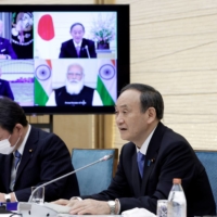 Prime Minister Yoshihide Suga speaks in a videoconference with U.S. President Joe Biden, Australian Prime Minister Scott Morrison and Indian Prime Minister Narendra Modi during the virtual Quadrilateral Security Dialogue, or \"Quad\" meeting in Tokyo on March 12. | POOL / VIA REUTERS