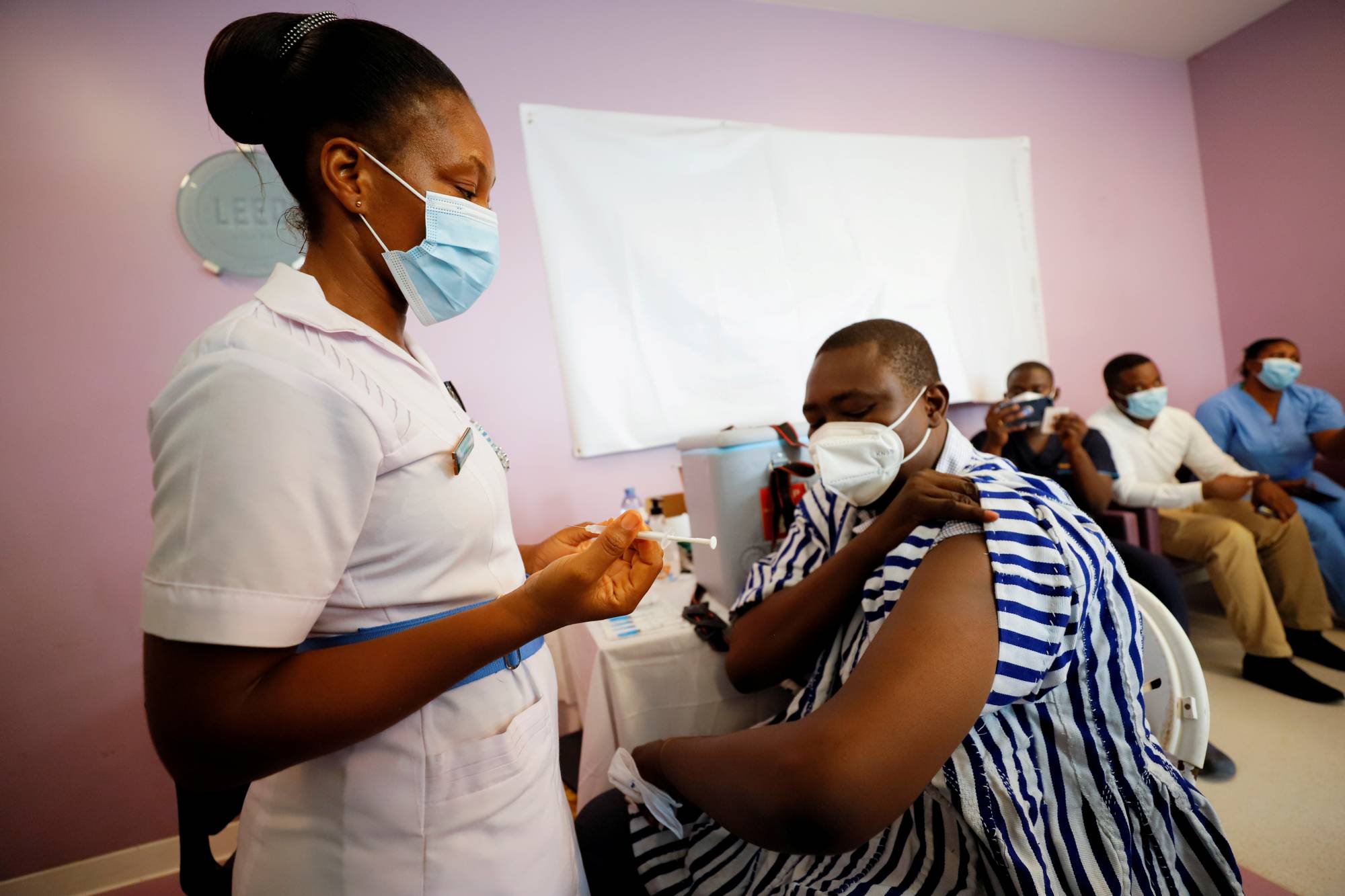 Medical officer Dr. Emmanuel Addipa-Adapoe, 42, receives the coronavirus vaccine in Accra, Ghana, on March 2.  | REUTERS