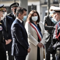 Paris Mayor Anne Hidalgo meets with family during a ceremony in tribute of a French policeman who was killed in 2017, in Paris on Tuesday. | AFP-JIJI