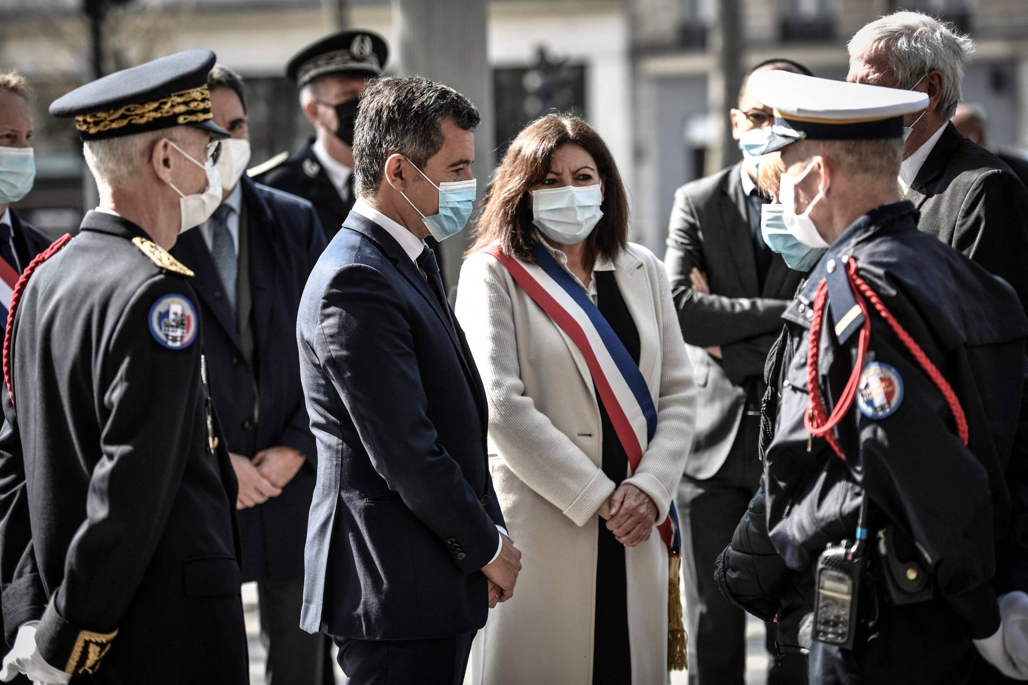 Paris Mayor Anne Hidalgo meets with family during a ceremony in tribute of a French policeman who was killed in 2017, in Paris on Tuesday. | AFP-JIJI
