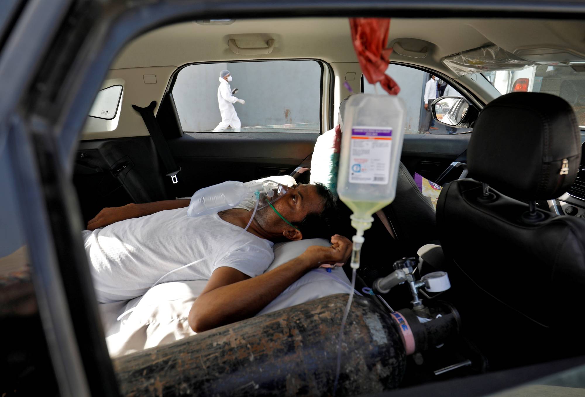 A patient with breathing problems waits to enter a COVID-19 hospital for treatment in Ahmedabad, India, on Thursday.  | REUTERS 