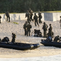 U.S. Marines take part in a landing exercise during a joint drill with the Ground Self-Defense Force on Feb. 1 at the Blue Beach training area in the town of Kin in Okinawa Prefecture. | KYODO

