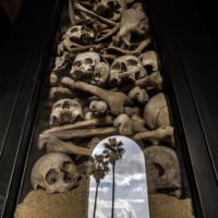 A glass-encased tower of skulls, and trees seen in a reflection at the the Armenian Catholicosate of Cilicia, an Orthodox church in Antelias, Lebanon, in March 2015. At the risk of infuriating Turkey, President Joe Biden is set to formally announce that the United States regards the killing of 1.5 million Armenians more than a century ago to be a genocide.  | BRYAN DENTON/THE NEW YORK TIMES