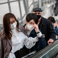 People visit a shopping mall in Tokyo on Saturday, a day before a new coronavirus state of emergency covering Tokyo, Osaka, Kyoto and Hyogo prefectures went into effect. | AFP-JIJI