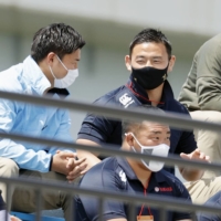 Retiring Yamaha fullback Ayumu Goromaru (top right) watches his team\'s Top League playoff game against the Spears on Saturday. | KYODO