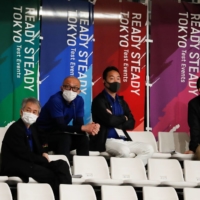 Officials wearing protective face masks watch the Tokyo 2020 track cycling test event at Izu Velodrome in Izu, Shizuoka Prefecture, on Sunday. | REUTERS