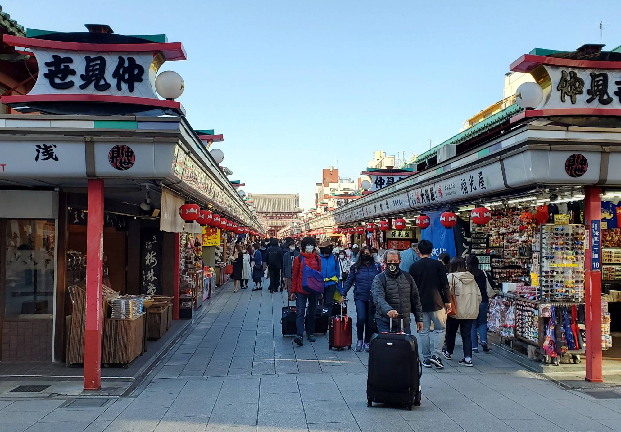 Tourists make their way through Tokyo's Asakusa neighborhood in March 2020. | REUTERS