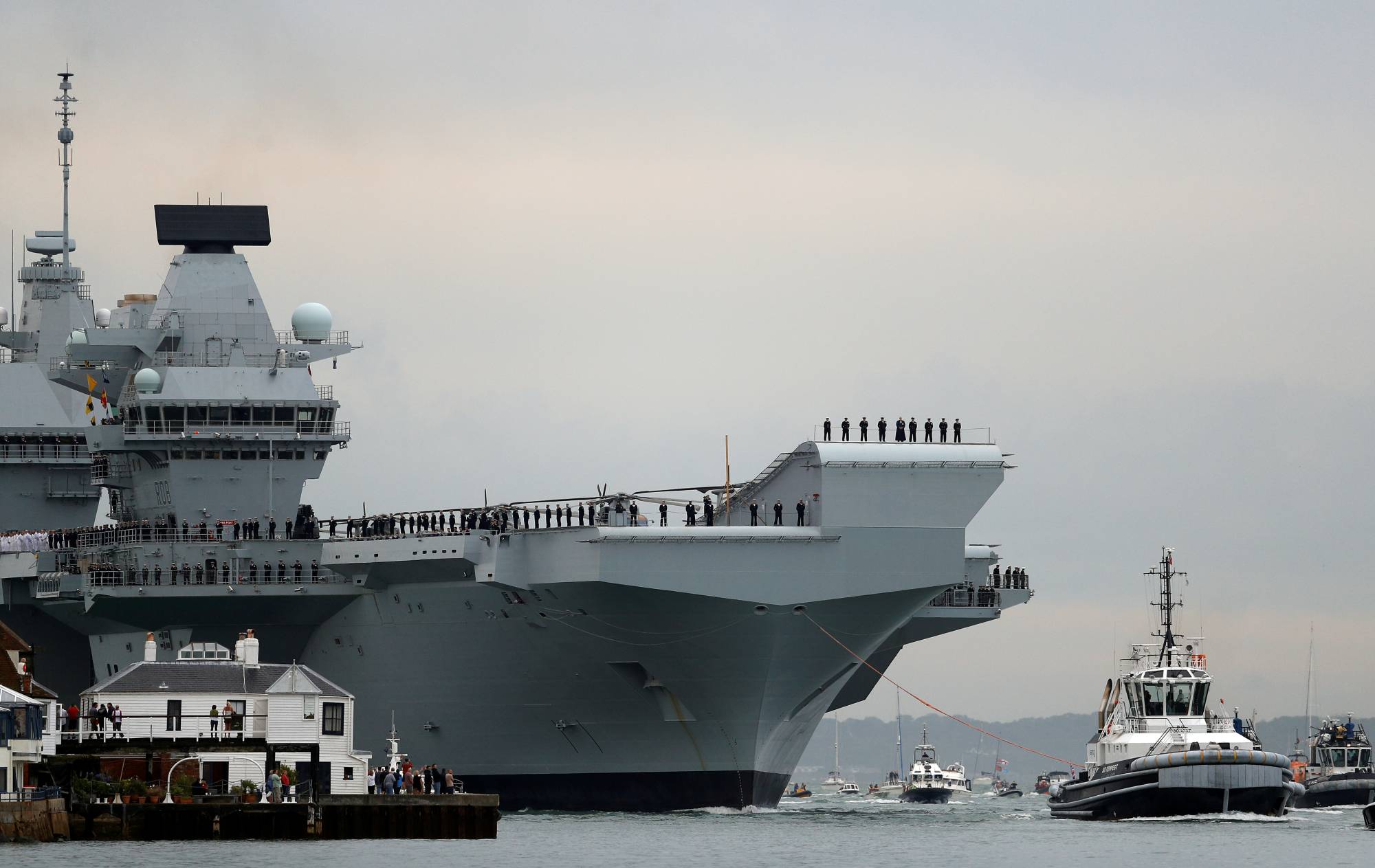 Britain's HMS Queen Elizabeth aircraft carrier will lead a flotilla of Royal Navy ships through Asian waters on port visits to Japan and South Korea on its maiden deployment, the British Embassy in Tokyo said Monday. | REUTERS