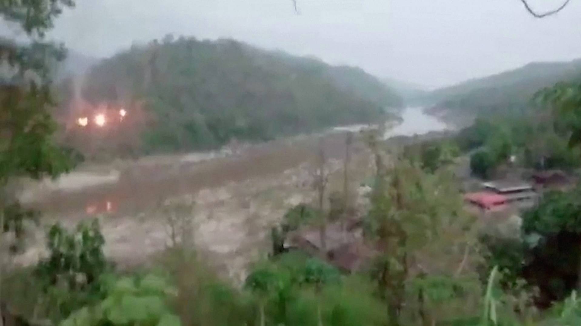 Fires burn on a forested hillside in Myanmar on Tuesday as shots are heard in the distance, as seen across the Salween river from Mae Sam Laep, a border outpost in northwestern Thailand.  | REUTERS
