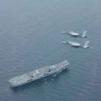 U.S. Navy F/A-18E and F/A-18F Super Hornets fly in formation above the British Navy aircraft carrier HMS Queen Elizabeth during a military exercise in the Atlantic Ocean in August 2017. | U.S. NAVY / VIA REUTERS   