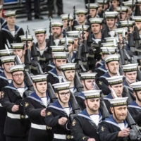 Members of the ship\'s company attend the commissioning ceremony for the British Navy\'s aircraft carrier HMS Queen Elizabeth in Portsmouth, England, in December 2017. | POOL / VIA REUTERS
