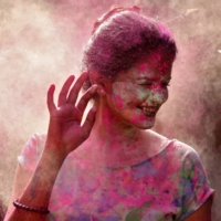 A woman reacts as color powder is thrown toward her during Holi celebrations in Chennai on March 29. | REUTERS