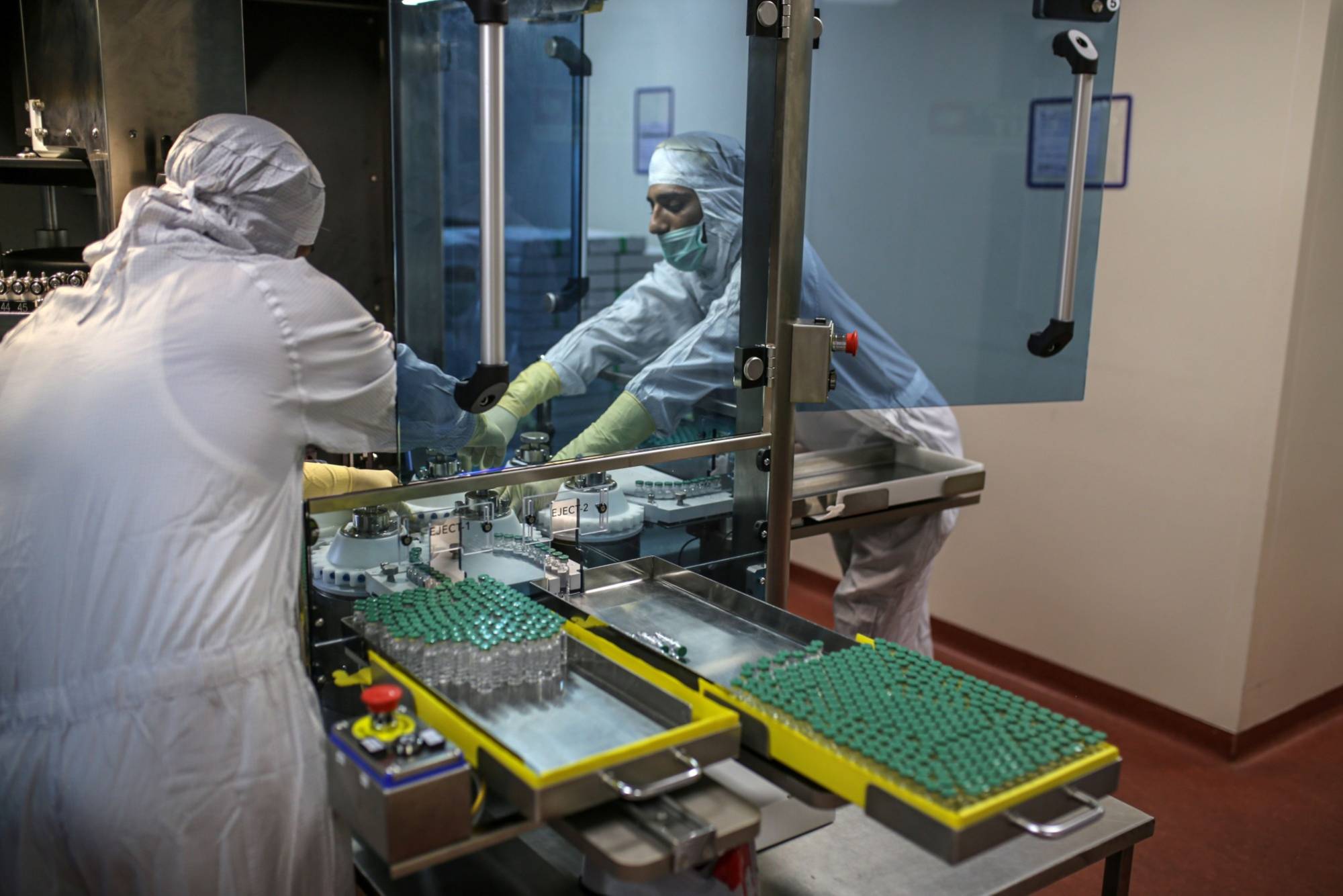 Employees work on the production of line for Covishield, the local name for the COVID-19 vaccine developed by AstraZeneca PLC and the University of Oxford, at the Serum Institute of India Ltd. Hadaspar plant in Pune, Maharashtra, India, in January. | Bloomberg 