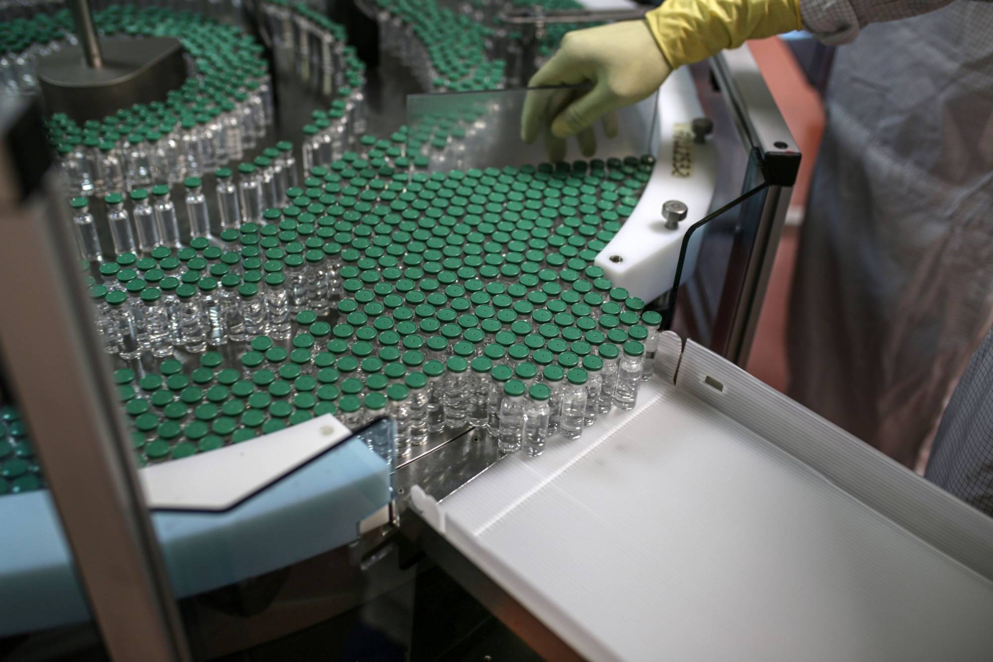 An employee monitors vials of the Covishield vaccine moving along the production line at the Serum Institute of India in Pune in January. | Bloomberg 