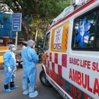 Health workers turn away an ambulance at the main entrance of the Lok Nayak Jaiprakash Hospital in New Delhi on Sunday.  | BLOOMBERG 