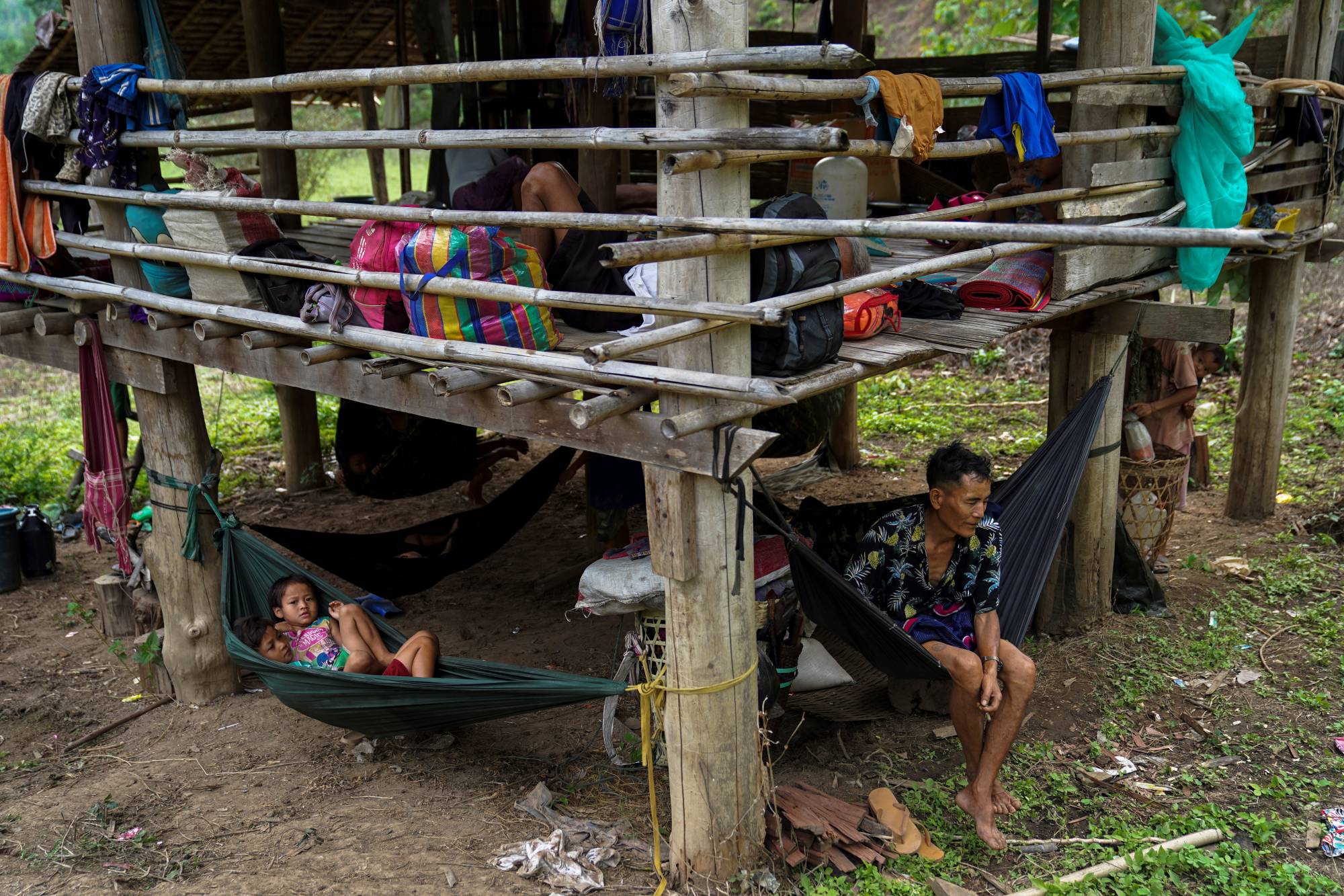 Villagers who fled Myanmar's Ee Thu Hta displacement camp rest in Mae Hong Son province, Thailand, on Thursday, after fleeing from gunfire between ethnic minority Karen insurgents and the Myanmar military. | REUTERS 