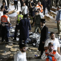 Rescue workers respond after dozens of people were killed in a crush at a religious bonfire in Mount Meron, northern Israel, on Friday.  | JINIPIX / VIA REUTERS 