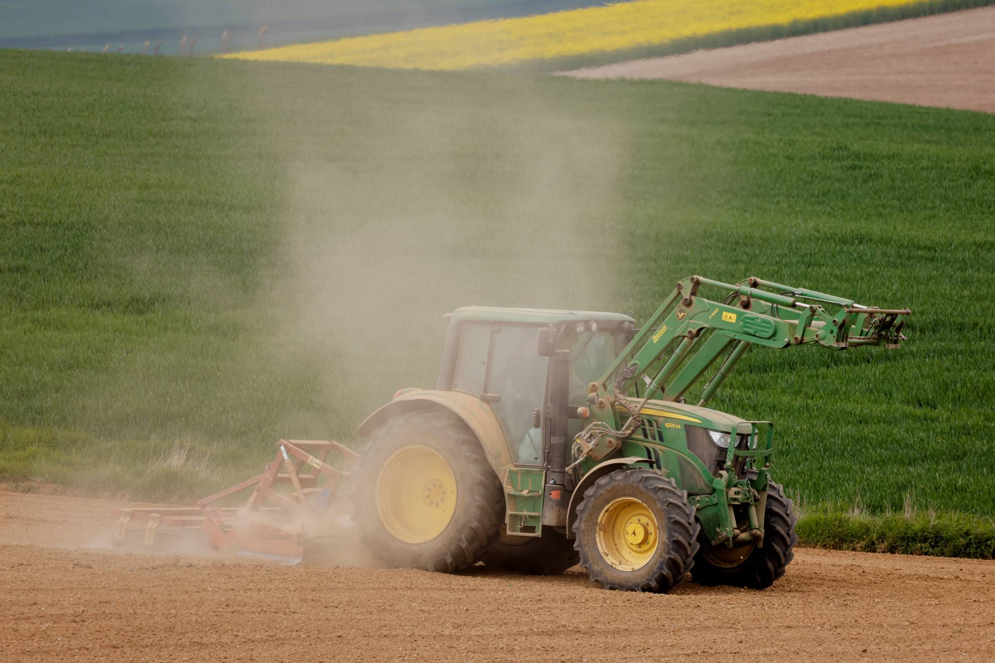 A French farmer driving a tractor on Friday raises a cloud of dust on his field in Gouzeaucourt as drought hits France.  | Reuters