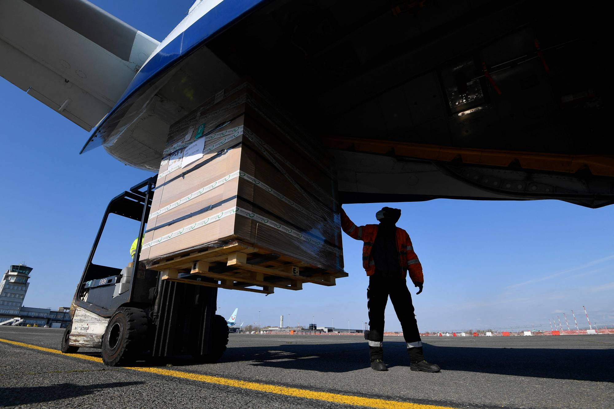A worker loads medical supplies bound for India at the Oostende-Bruges Airport in Belgium on Friday. | AFP-JIJI