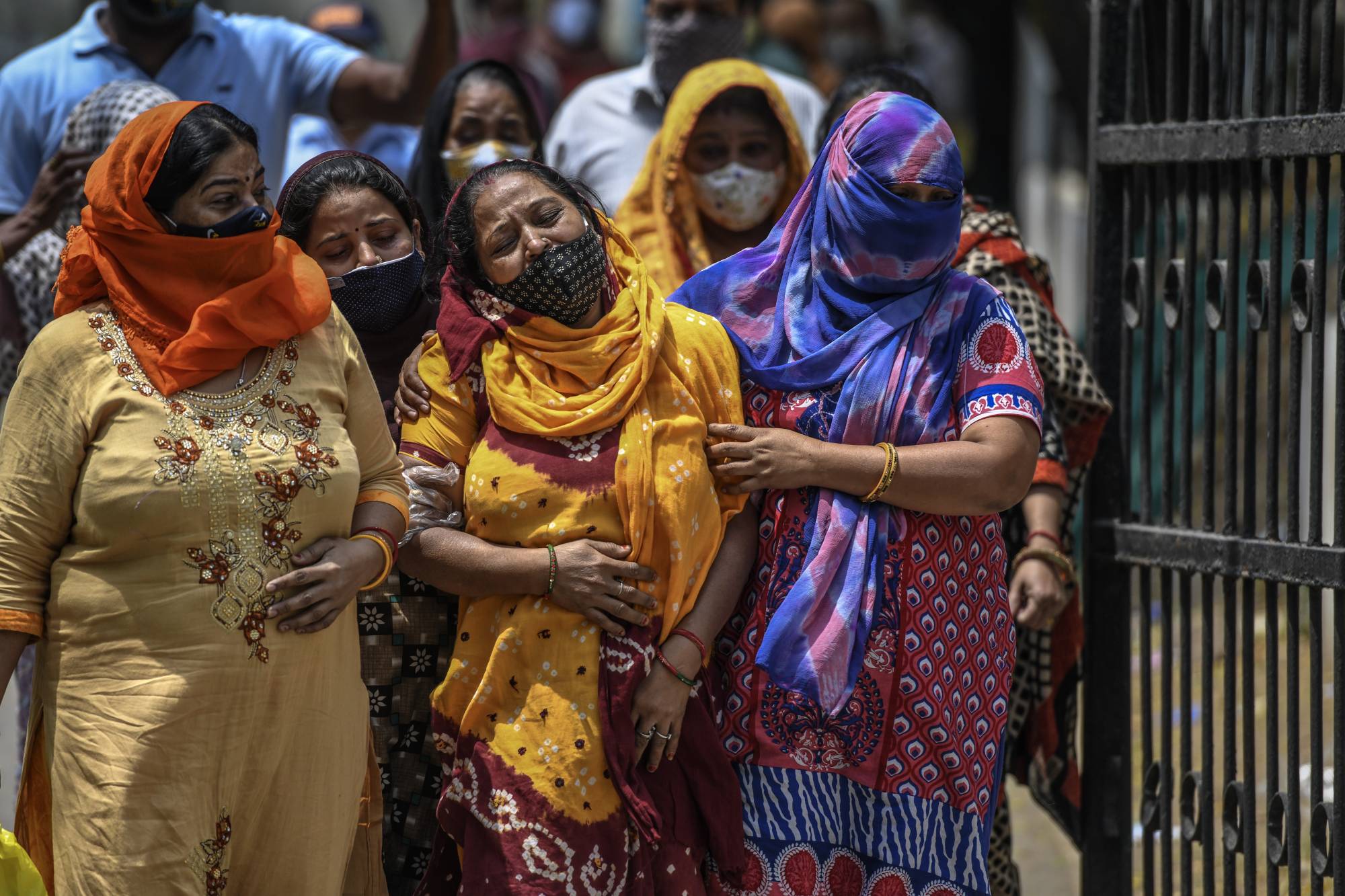 Relatives of COVID-19 victims mourn outside a hospital mortuary in Delhi on April 23. | Atul Loke / The New York Times 