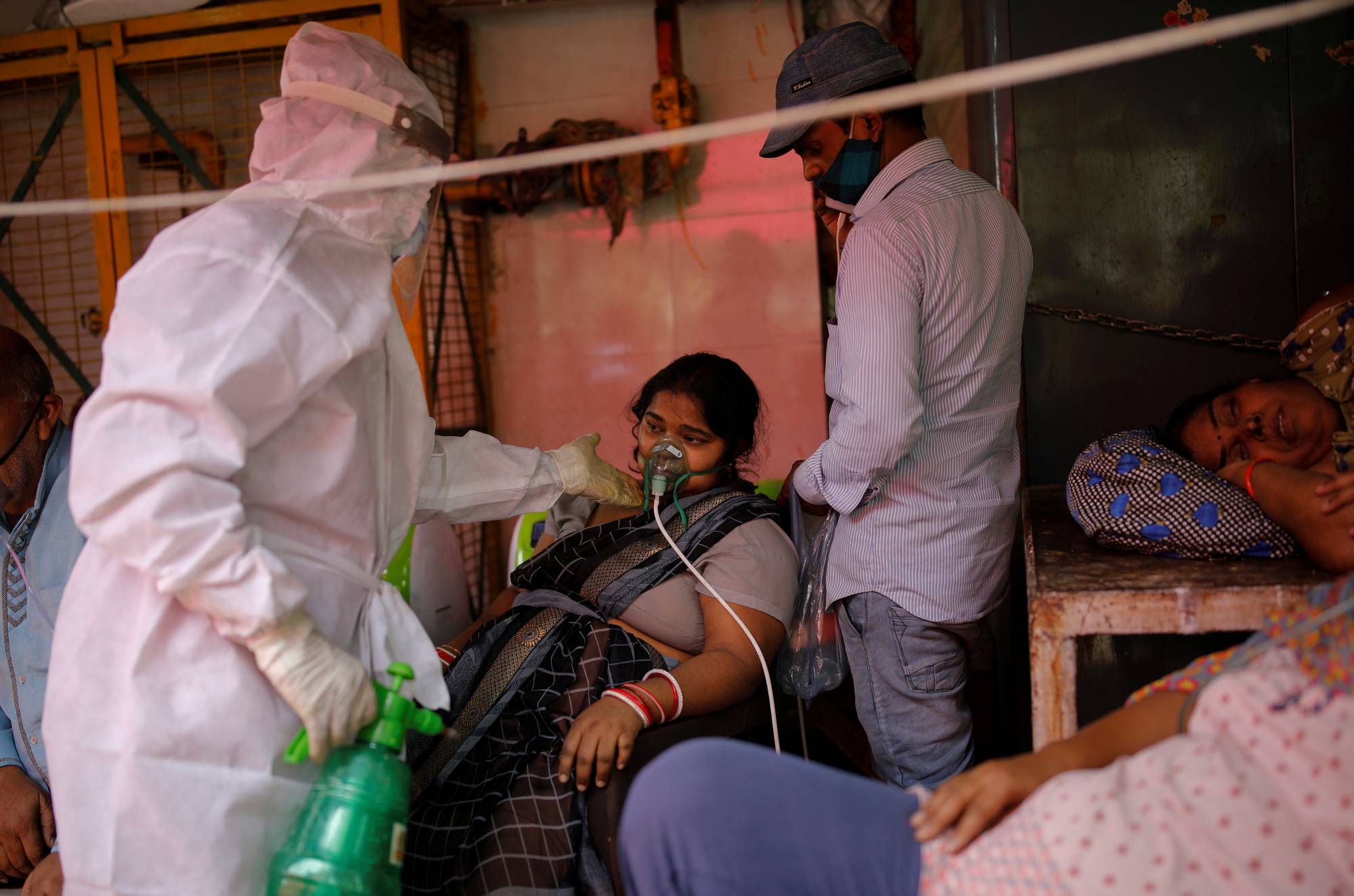 A woman with a breathing problem receives oxygen support at a temple in Ghaziabad, India, on Friday. | Reuters 