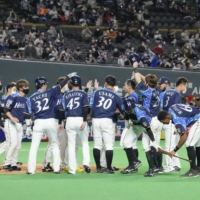 The Fighters celebrate their win over the Lions on Saturday in Sapporo. | KYODO
