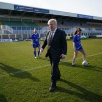 British Prime Minister Boris Johnson speaks with members of the Hartlepool United Ladies Team during a visit in Hartlepool, England, on April 23.  | POOL / VIA REUTERS