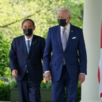 U.S. President Joe Biden and Prime Minister Yoshihide Suga head to a joint news conference at the White House in Washington on April 16. | AFP-JIJI