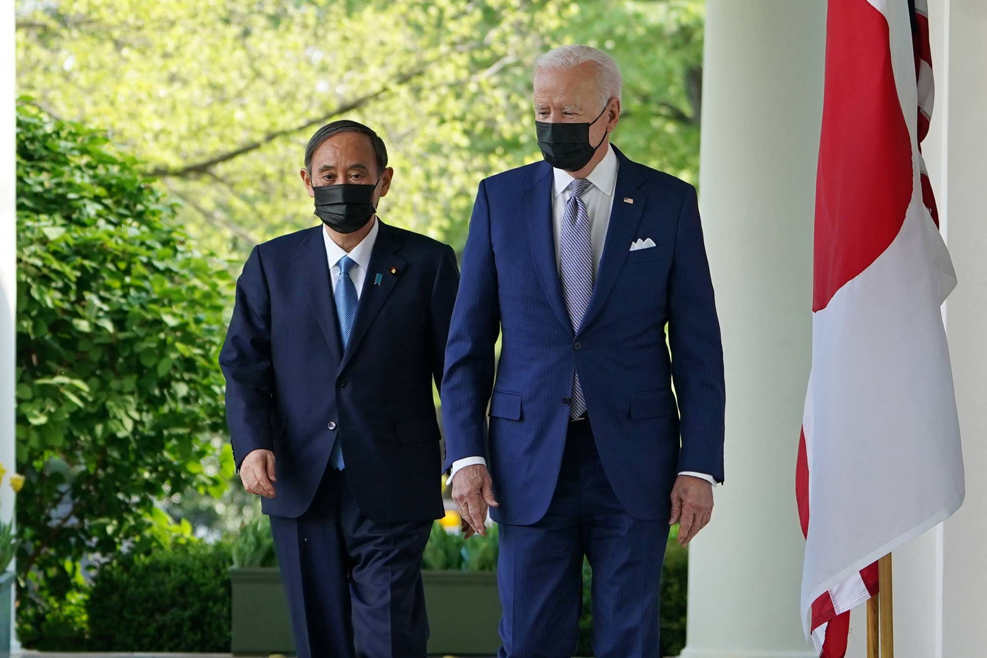 U.S. President Joe Biden and Prime Minister Yoshihide Suga head to a joint news conference at the White House in Washington on April 16. | AFP-JIJI