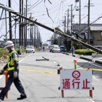 Meteorological authorities said they are investigating the possibility of tornadoes after building roofs were torn off, glass windows shattered and cars thrown on their sides in Makinohara, Shizuoka Prefecture. | KYODO