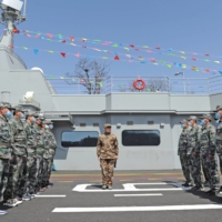 Chinese militia members attend a ceremony marking the completion of a military park in the shape of an aircraft carrier in Dalian, China, on  April 16. China’s Shandong aircraft carrier task group recently conducted an exercise in the South China Sea, the country\'s People\'s Liberation Army (PLA) said Sunday.  | CHINA DAILY / VIA REUTERS  
