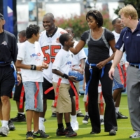 U.S. first lady Michelle Obama (second from right) participates in a flag football event with former NFL coach Tony Dungy (second from left), and NFL Commissioner Roger Goodell (right) as part of her campaign to fight child obesity on Sept. 8, 2018, in New Orleans. | REUTERS