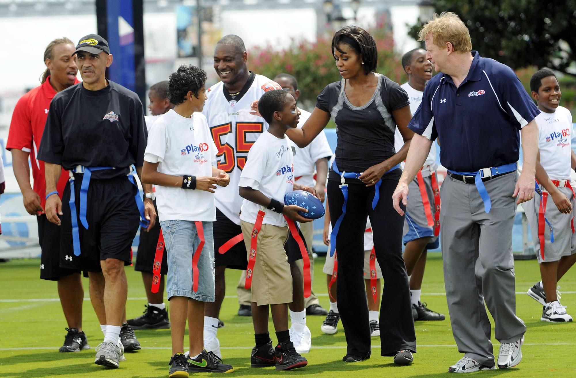 U.S. first lady Michelle Obama (second from right) participates in a flag football event with former NFL coach Tony Dungy (second from left), and NFL Commissioner Roger Goodell (right) as part of her campaign to fight child obesity on Sept. 8, 2018, in New Orleans. | Reuters