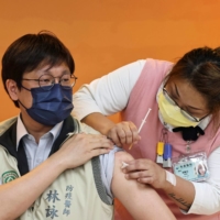 A doctor receives a dose of the AstraZeneca vaccine in Taoyuan, Taiwan, in April.  | REUTERS