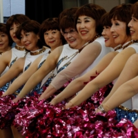 Members of cheer squad Japan Pom Pom post for commemorative photos before filming a dance routine for an online performance in Tokyo, Japan, April 12. | REUTERS