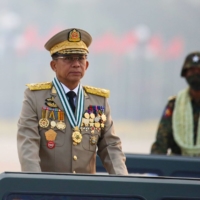 Myanmar\'s junta chief and head of the Tatmadaw, Senior Gen. Min Aung Hlaing, presides over an army parade on Armed Forces Day in Naypyitaw on March 27.   | REUTERS