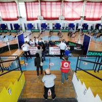 People arrive to receive a dose of China\'s Sinopharm COVID-19 vaccine at a sports center in Stip, North Macedonia, on Thursday. | REUTERS