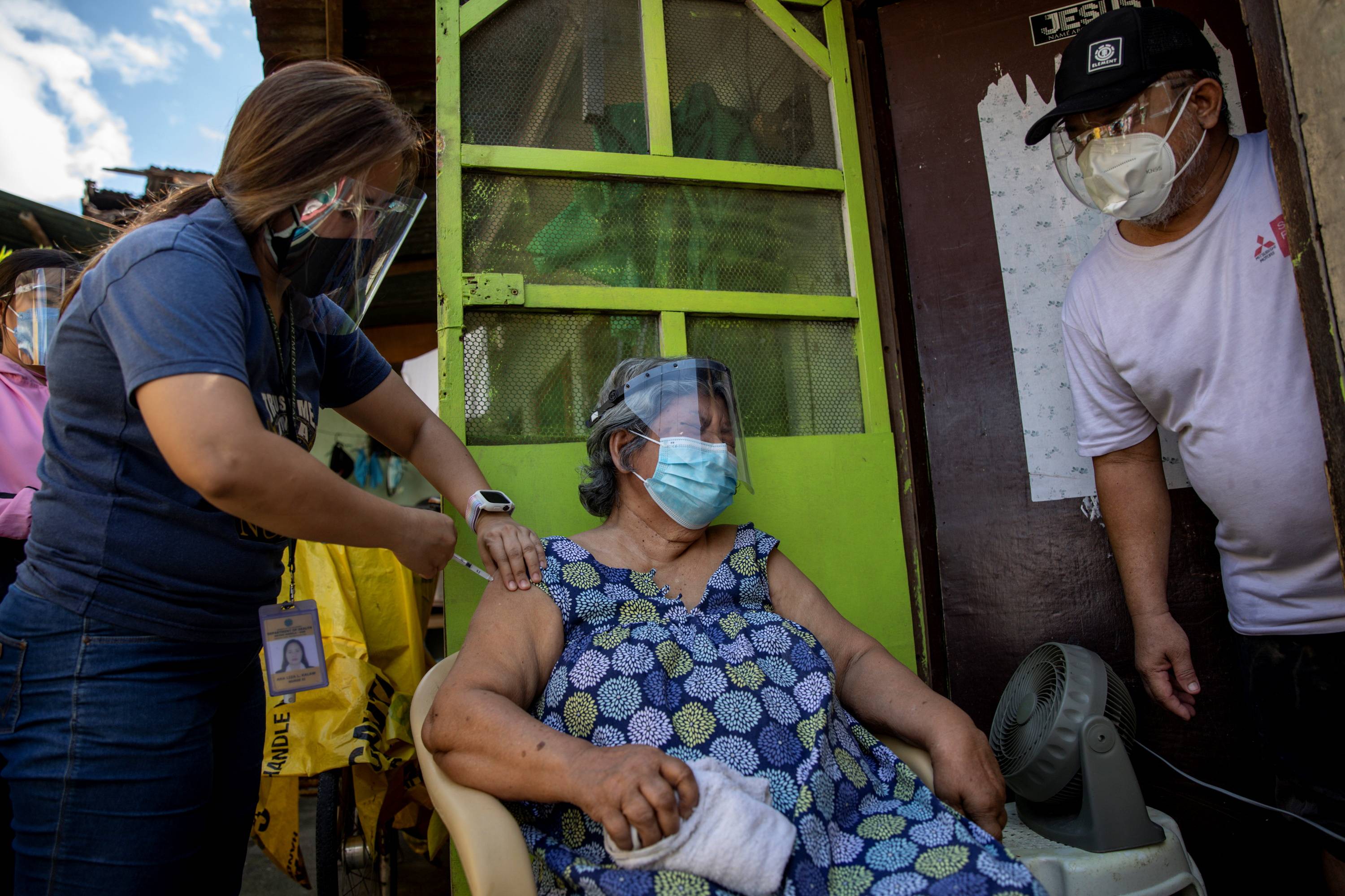 Francia Nolasco, 78, gets a shot of China's Sinovac COVID-19 vaccine in Metro Manila on Wednesday. India’s export delays deprived the Philippines of its biggest vaccine order at a time when it is sparring with China over a territorial dispute. | Reuters