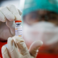 A medical worker holds a dose of the Sinovac vaccine at a district health facility in Jakarta in January. Countries from Uruguay to Senegal to Indonesia have had few places to turn to for COVID-19 vaccines apart from Beijing. | REUTERS