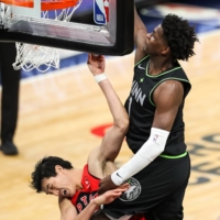 Minnesota Timberwolves forward Anthony Edwards dunks the ball against Toronto Raptors forward Yuta Watanabe in the third quarter at Target Center in Minneapolis on Feb 19.  | DAVID BERDING / USA TODAY / VIA REUTERS