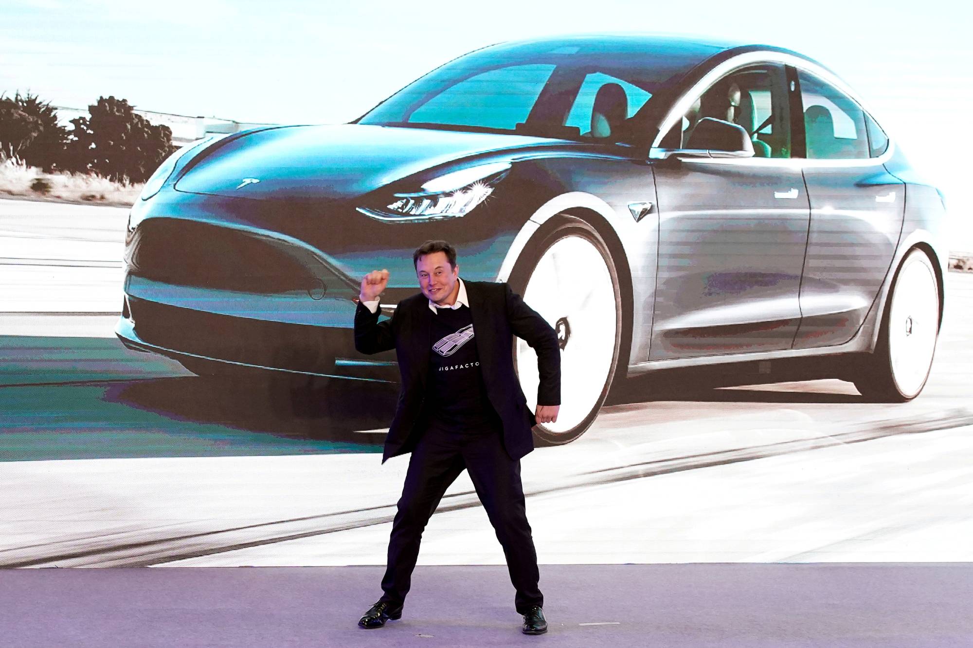 Tesla Inc. CEO Elon Musk dances onstage during a delivery event for Tesla's China-made Model 3 cars in Shanghai in January 2020. | Reuters 
