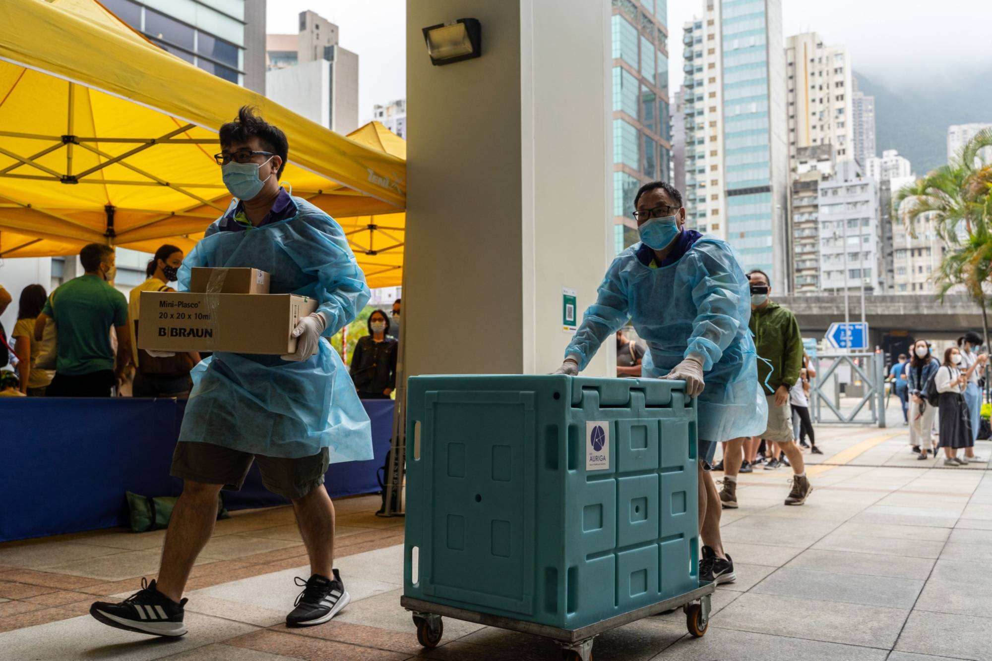 Staff members transport medical materials to a community vaccination center in Hong Kong. | Bloomberg 